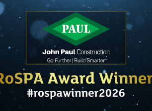 > John Paul Construction graphic announcing "RoSPA Award Winner!" with the 2026 hashtag, company logo, and RoSPA Health & Safety Awards branding on a dark, textured blue background.